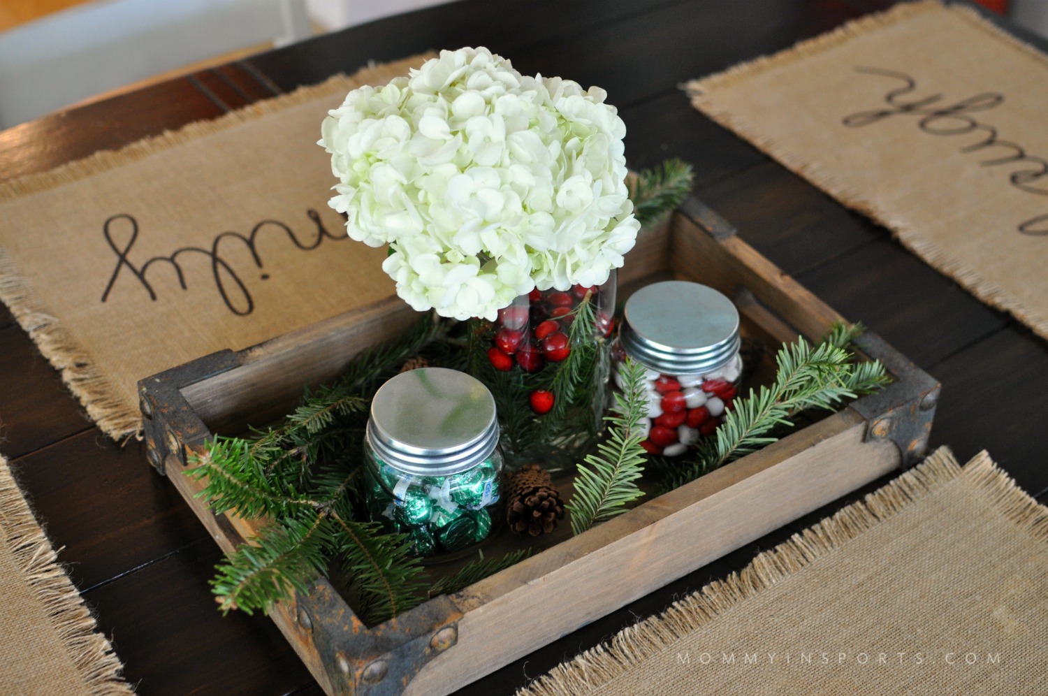 A wooden box or wine crate is perfect for an ottoman tray or centerpiece! Fill with flowers, cranberries, Christmas tree clippings and jars of candy to create a simple DIY holiday centerpiece!